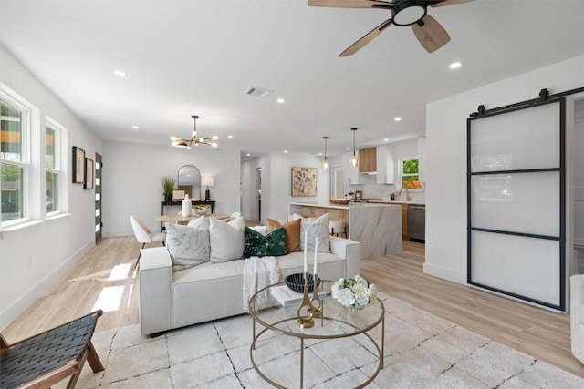 5604 Overbrook Dr, Austin, TX 78723 - living area featuring a barn door, light wood-style flooring, recessed lighting, a chandelier, and a ceiling fan
