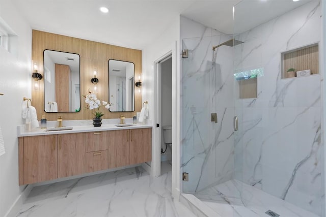 5604 Overbrook Dr, Austin, TX 78723 - bathroom featuring a marble finish shower, double vanity, marble finish flooring, and recessed lighting