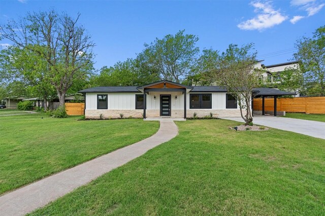 5604 Overbrook Dr, Austin, TX 78723 - view of front of house featuring board and batten siding, stone siding, and concrete driveway