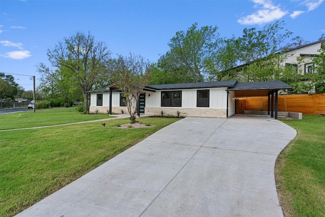 5604 Overbrook Dr, Austin, TX 78723 - view of front of home featuring concrete driveway, stone siding, and an attached carport