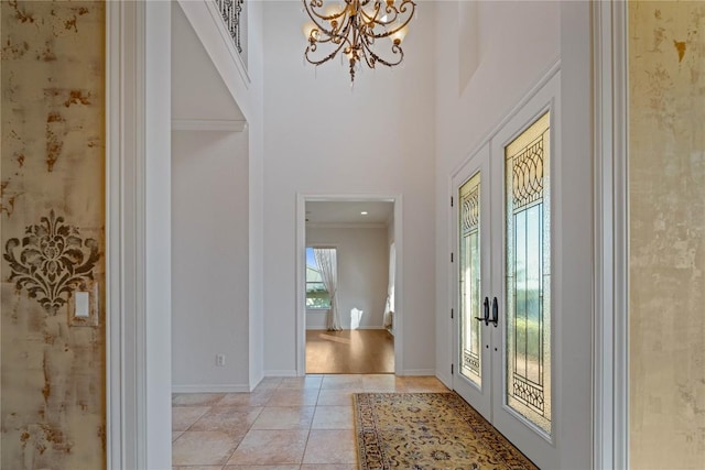 758 Mission Hts, New Braunfels, TX 78130 - foyer with a chandelier, light tile patterned floors, ornamental molding, and a towering ceiling