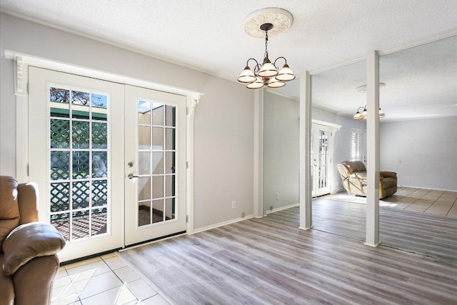 6718 Silvermine Dr Unit 201, Austin, TX 78736 - doorway to outside with french doors, a chandelier, healthy amount of natural light, wood finished floors, and a textured ceiling