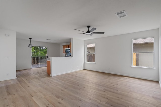 17129 Hamilton Point Cir, Manor, TX 78653 - unfurnished living room featuring light wood-type flooring and a ceiling fan