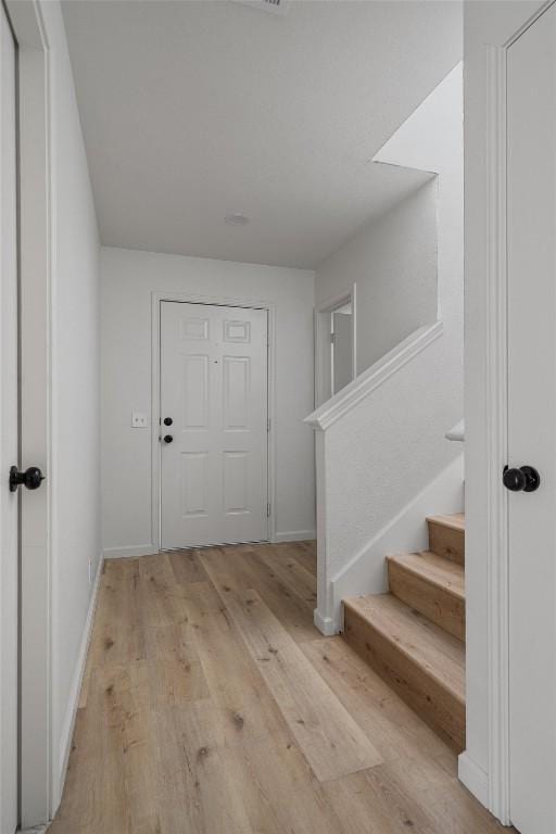 17129 Hamilton Point Cir, Manor, TX 78653 - entrance foyer featuring light wood finished floors and stairway