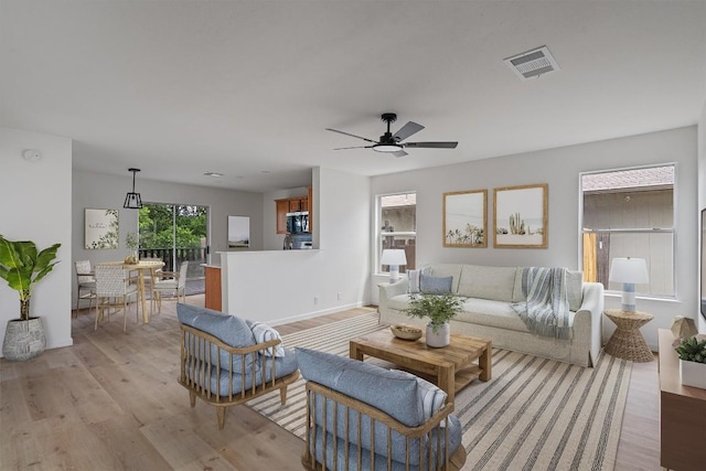 17129 Hamilton Point Cir, Manor, TX 78653 - living room featuring light wood finished floors and a ceiling fan