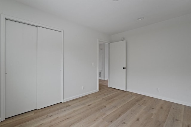 17129 Hamilton Point Cir, Manor, TX 78653 - unfurnished bedroom with wood finished floors and a closet