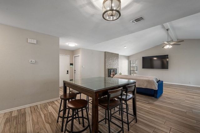1300 Neans Dr, Austin, TX 78758 - dining space featuring wood finished floors, a fireplace, and a ceiling fan