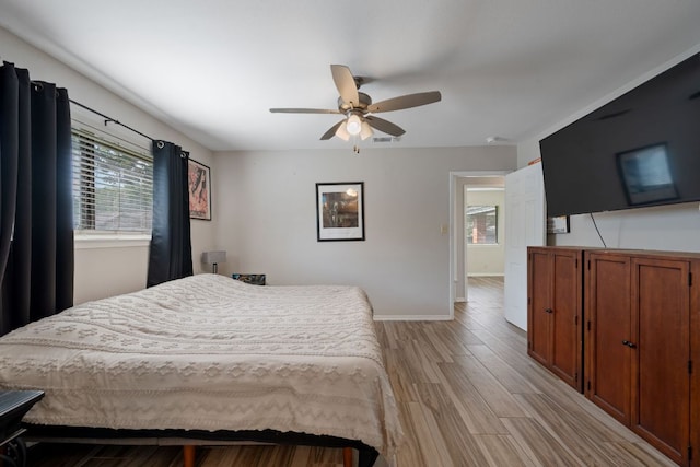 1300 Neans Dr, Austin, TX 78758 - bedroom with multiple windows, light wood-style floors, and a ceiling fan