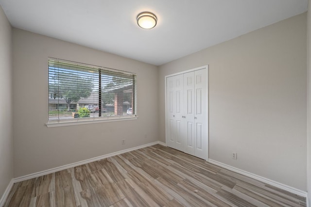 1300 Neans Dr, Austin, TX 78758 - unfurnished bedroom with wood finished floors and a closet