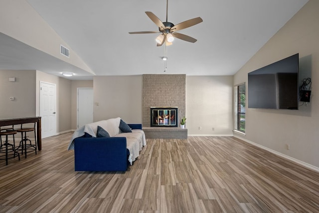 1300 Neans Dr, Austin, TX 78758 - living room featuring wood finished floors, a ceiling fan, high vaulted ceiling, and a brick fireplace