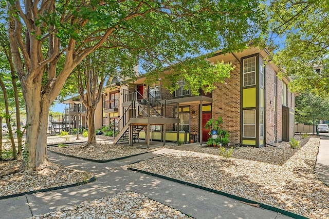 7685 Northcross Dr Unit 720, Austin, TX 78757 - view of front facade with stairway and brick siding