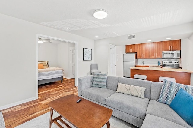 7685 Northcross Dr Unit 720, Austin, TX 78757 - living area featuring light wood finished floors and recessed lighting