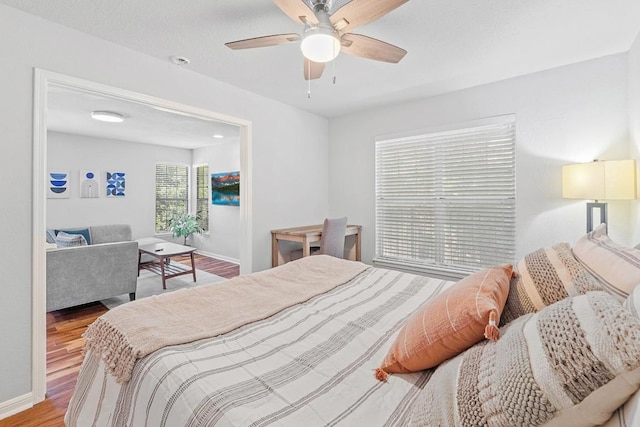 7685 Northcross Dr Unit 720, Austin, TX 78757 - bedroom featuring wood finished floors and a ceiling fan