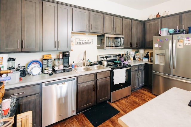 8601 W Gate Blvd Unit 11101, Austin, TX 78745 - kitchen with appliances with stainless steel finishes, light countertops, dark brown cabinets, and dark wood-style floors