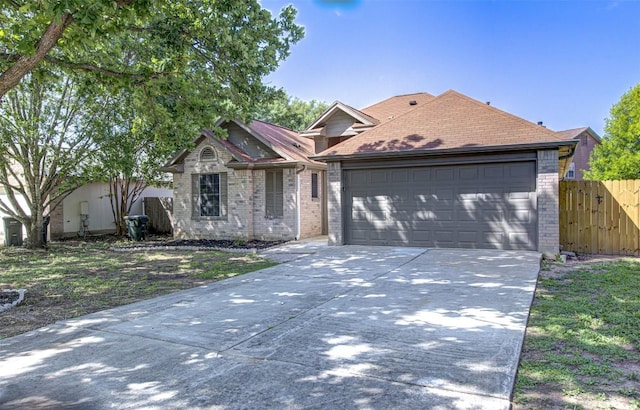 430 Zebra Dr, Kyle, TX 78640 - view of front of house with brick siding, concrete driveway, a garage, and roof with shingles