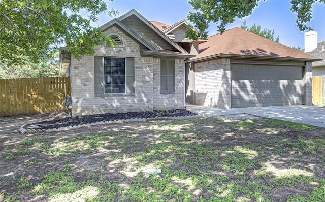 430 Zebra Dr, Kyle, TX 78640 - view of front of house featuring an attached garage, driveway, and brick siding