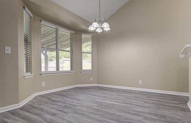 430 Zebra Dr, Kyle, TX 78640 - unfurnished room with wood finished floors, a chandelier, and lofted ceiling