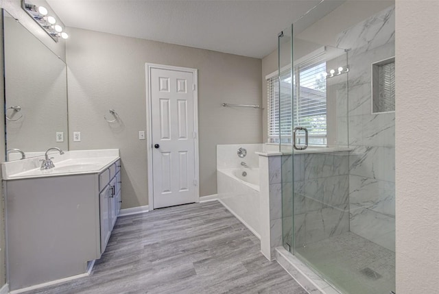 430 Zebra Dr, Kyle, TX 78640 - full bath with vanity, a garden tub, wood finished floors, and a marble finish shower