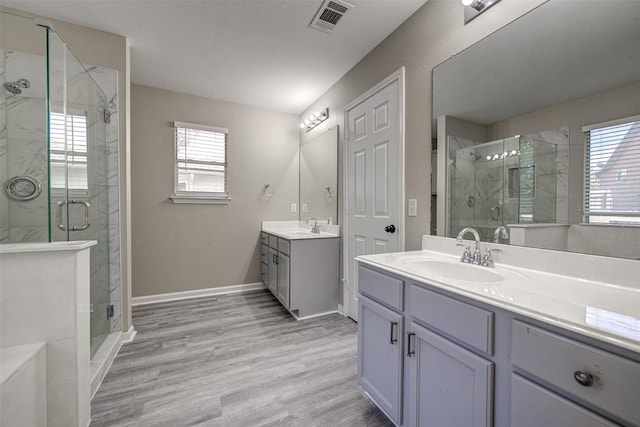 430 Zebra Dr, Kyle, TX 78640 - full bath featuring a marble finish shower, two vanities, and wood finished floors