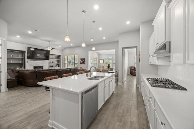 270 Baldovino Skwy, Lakeway, TX 78738 - kitchen featuring appliances with stainless steel finishes, under cabinet range hood, ceiling fan, open floor plan, and recessed lighting