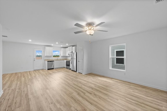 470 Aplite Pass, Maxwell, TX 78656 - unfurnished living room with light wood-style flooring, recessed lighting, and a ceiling fan