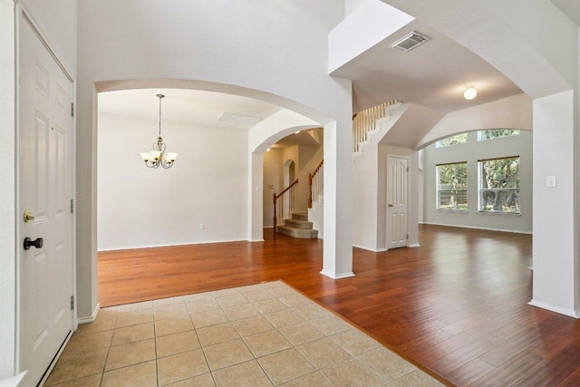 411 S Lynnwood Trl, Cedar Park, TX 78613 - entrance foyer featuring wood finished floors, stairs, a chandelier, and arched walkways