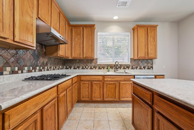 411 S Lynnwood Trl, Cedar Park, TX 78613 - kitchen featuring under cabinet range hood, stainless steel gas cooktop, light countertops, brown cabinetry, and recessed lighting