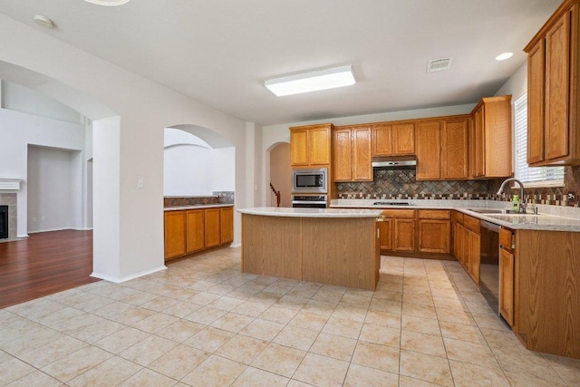 411 S Lynnwood Trl, Cedar Park, TX 78613 - kitchen featuring appliances with stainless steel finishes, under cabinet range hood, decorative backsplash, light countertops, and light tile patterned floors
