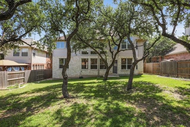 411 S Lynnwood Trl, Cedar Park, TX 78613 - back of property with stone siding and a fenced backyard