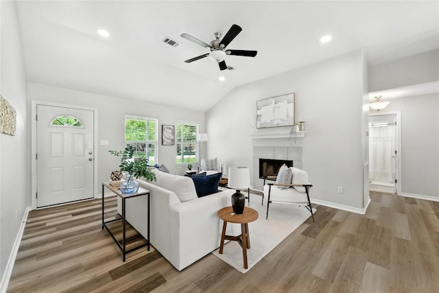 118 W Pauwela Ln, Bastrop, TX 78602 - living area with a fireplace, lofted ceiling, ceiling fan, light wood-style flooring, and recessed lighting