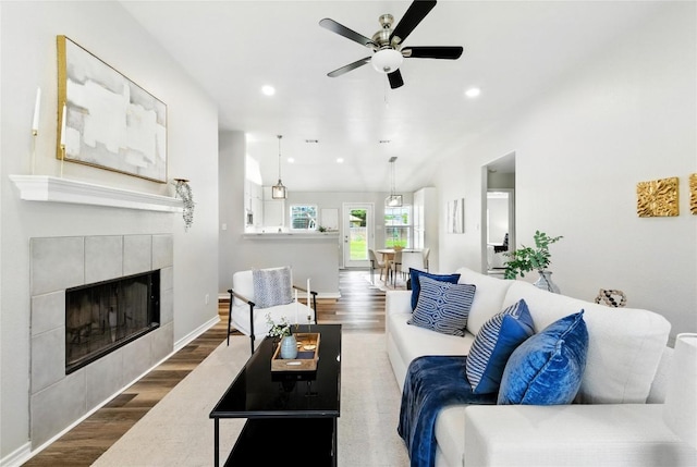 118 W Pauwela Ln, Bastrop, TX 78602 - living room with wood finished floors, ceiling fan, a fireplace, and recessed lighting