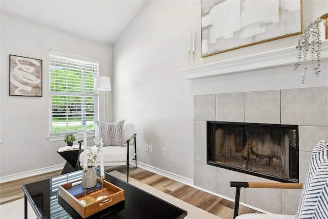 118 W Pauwela Ln, Bastrop, TX 78602 - sitting room with a fireplace, wood finished floors, and vaulted ceiling
