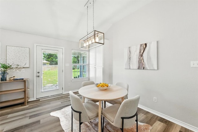 118 W Pauwela Ln, Bastrop, TX 78602 - dining space featuring wood finished floors, a chandelier, and vaulted ceiling