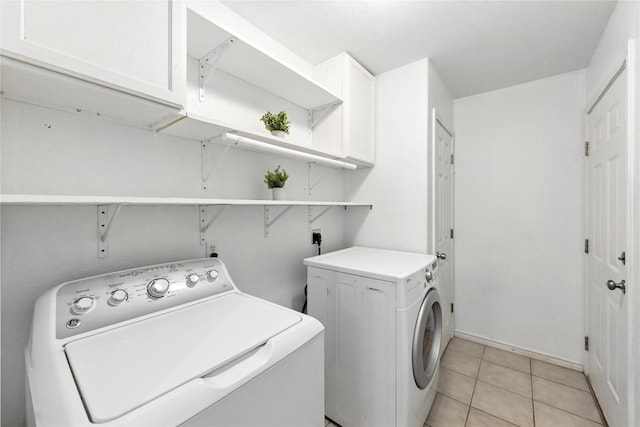 118 W Pauwela Ln, Bastrop, TX 78602 - laundry room featuring washing machine and dryer, cabinet space, and light tile patterned floors