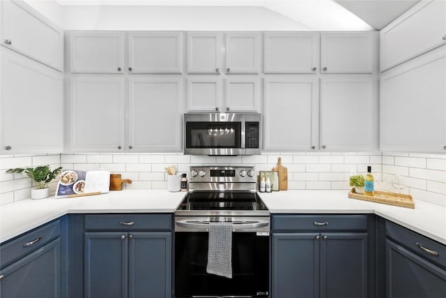 118 W Pauwela Ln, Bastrop, TX 78602 - kitchen with stainless steel appliances, light countertops, decorative backsplash, and blue cabinets