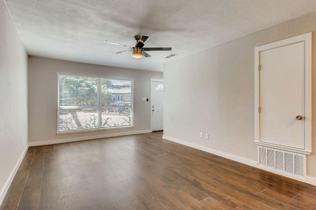 5808 Cherry Park, Austin, TX 78745 - unfurnished room with a textured ceiling, dark wood-style flooring, a ceiling fan, and a textured wall