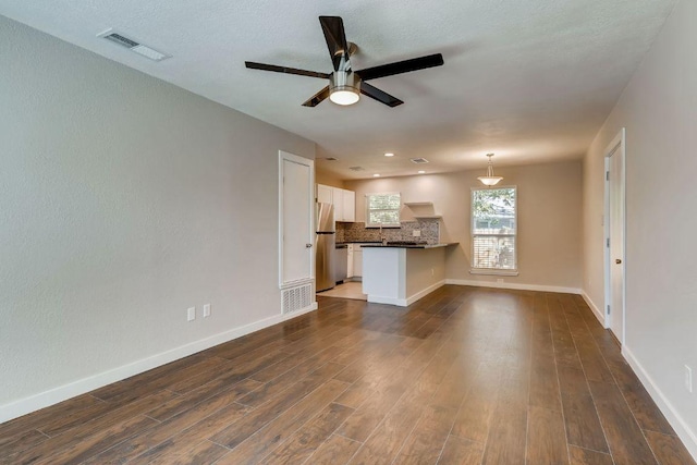 5808 Cherry Park, Austin, TX 78745 - unfurnished living room with a ceiling fan, dark wood-style floors, and recessed lighting