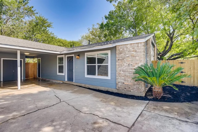 5808 Cherry Park, Austin, TX 78745 - view of front facade featuring brick siding, driveway, and a patio