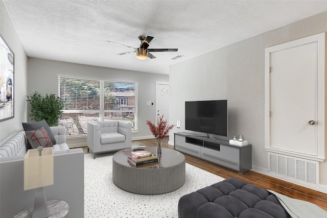 5808 Cherry Park, Austin, TX 78745 - living room featuring wood finished floors, a textured ceiling, a ceiling fan, and a textured wall