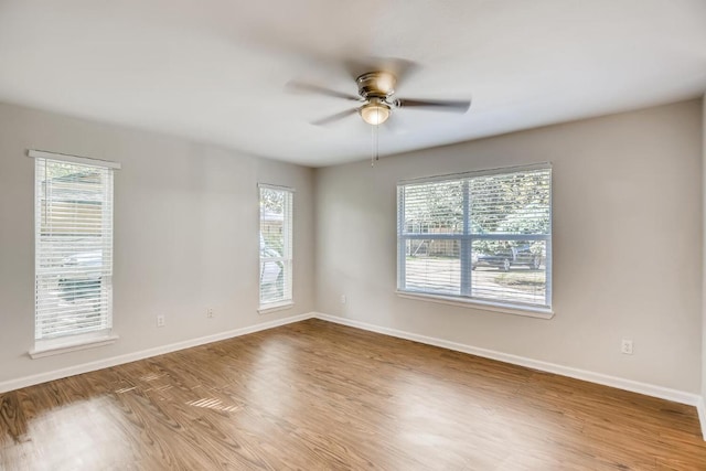 5808 Cherry Park, Austin, TX 78745 - unfurnished room with wood finished floors, healthy amount of natural light, and a ceiling fan