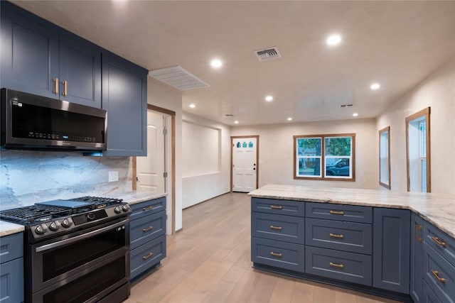318 W Hackberry St, Fredericksburg, TX 78624 - kitchen with stainless steel appliances, decorative backsplash, light wood-type flooring, light stone counters, and recessed lighting