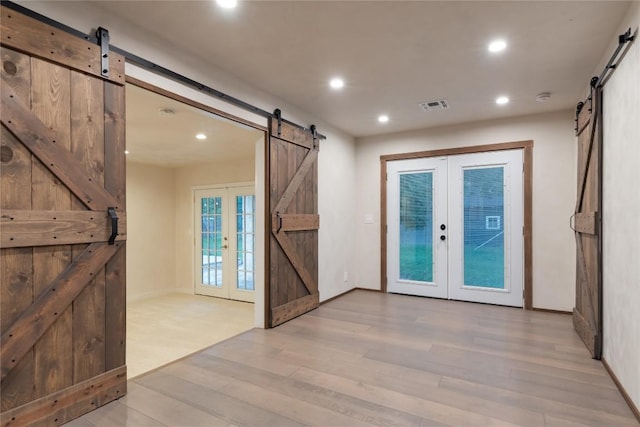 318 W Hackberry St, Fredericksburg, TX 78624 - entrance foyer featuring a barn door, french doors, light wood-type flooring, and recessed lighting
