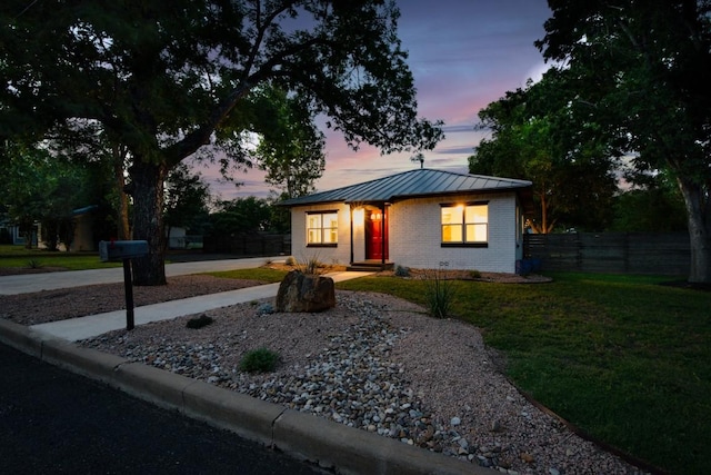 318 W Hackberry St, Fredericksburg, TX 78624 - view of front of house with brick siding, a standing seam roof, a metal roof, and driveway