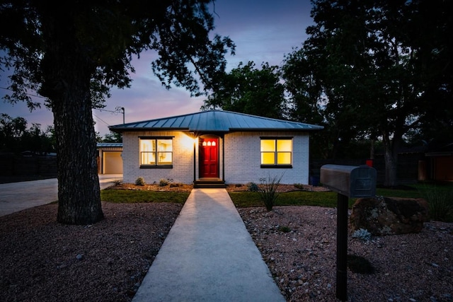 318 W Hackberry St, Fredericksburg, TX 78624 - bungalow-style house with a standing seam roof, brick siding, and a metal roof