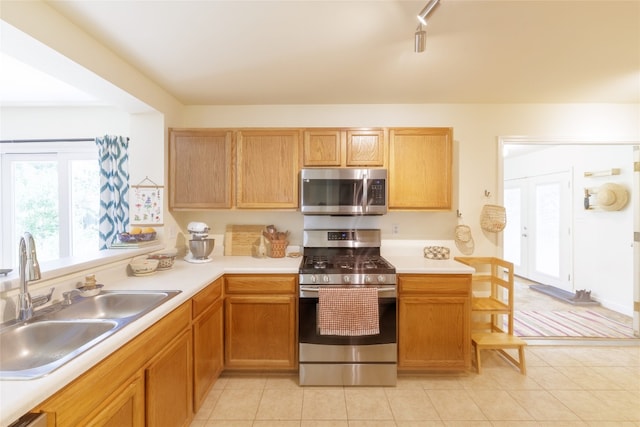 16704 Shipshaw River Cv, Leander, TX 78641 - kitchen with appliances with stainless steel finishes, light countertops, track lighting, and light tile patterned floors