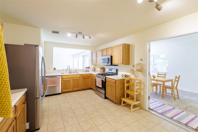 16704 Shipshaw River Cv, Leander, TX 78641 - kitchen with appliances with stainless steel finishes, track lighting, and light countertops