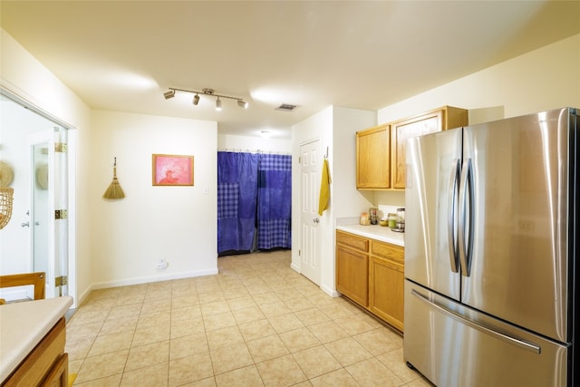 16704 Shipshaw River Cv, Leander, TX 78641 - kitchen featuring freestanding refrigerator, light tile patterned floors, and light countertops