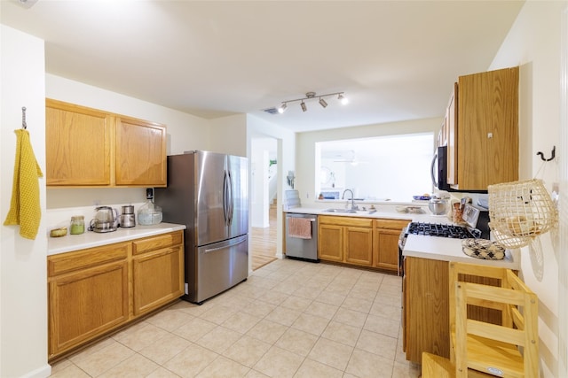 16704 Shipshaw River Cv, Leander, TX 78641 - kitchen with appliances with stainless steel finishes, light countertops, light tile patterned floors, and healthy amount of natural light