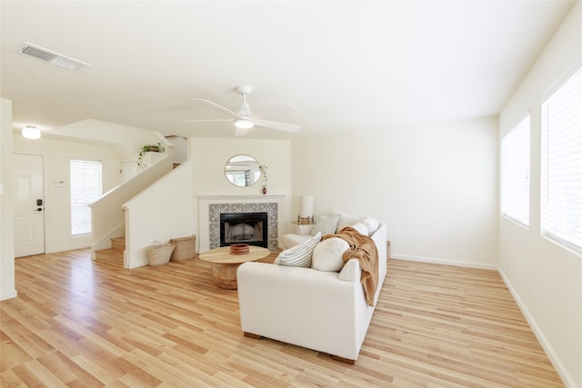 16704 Shipshaw River Cv, Leander, TX 78641 - living room with light wood-style flooring, stairway, a ceiling fan, and a fireplace