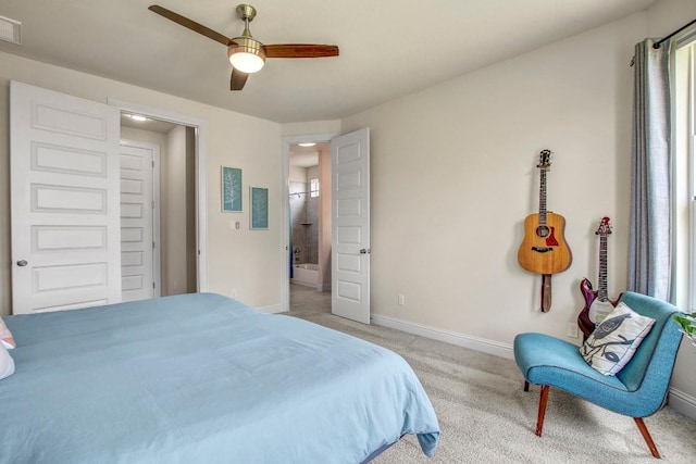 336 Gaida Loop, Georgetown, TX 78628 - bedroom with light carpet, multiple windows, ceiling fan, and connected bathroom